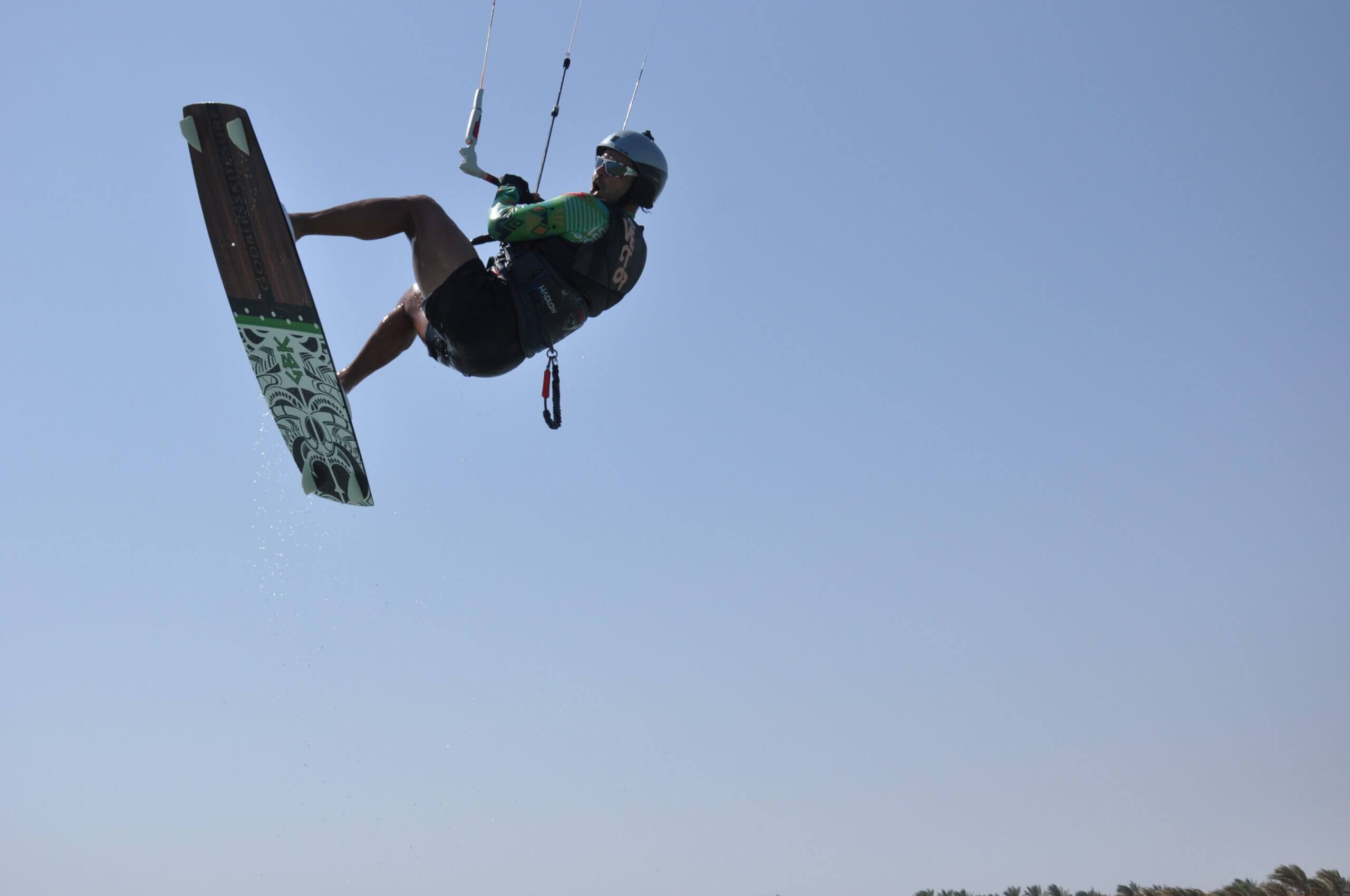 Kitesurfer performing a jump above the lagoon
