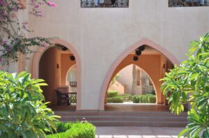 Arched entrance framed by flowers and greenery at the lagoon resort